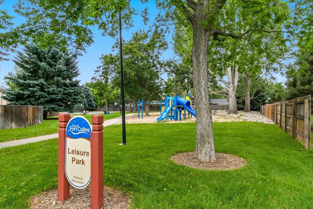 Leisure Park sign, playground, and shade trees in Midtown Fort Collins